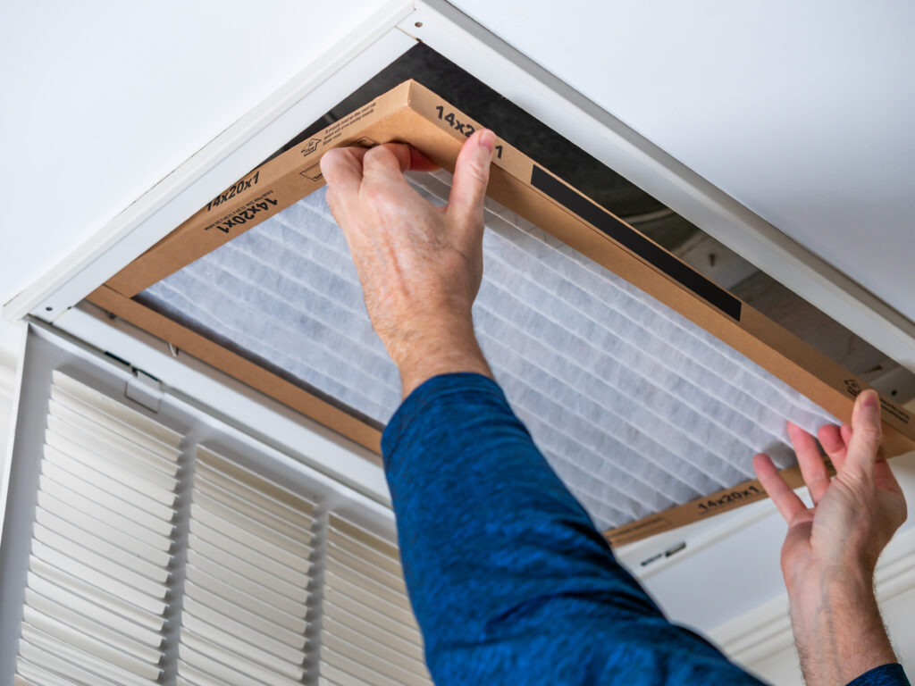 HVAC technician replacing a home air filter in Granite Bay