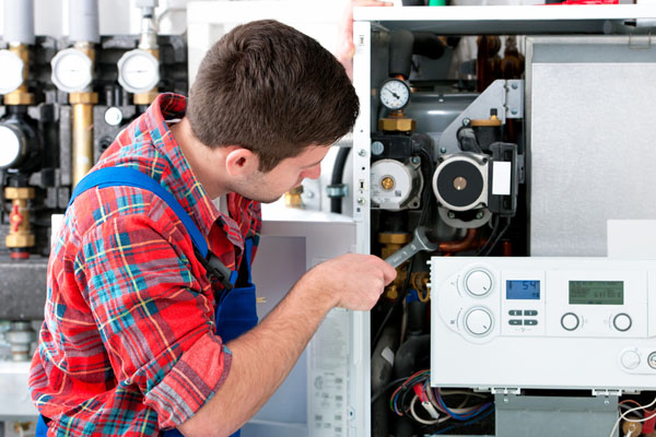 Heating technician repairing boiler controls in Granite Bay