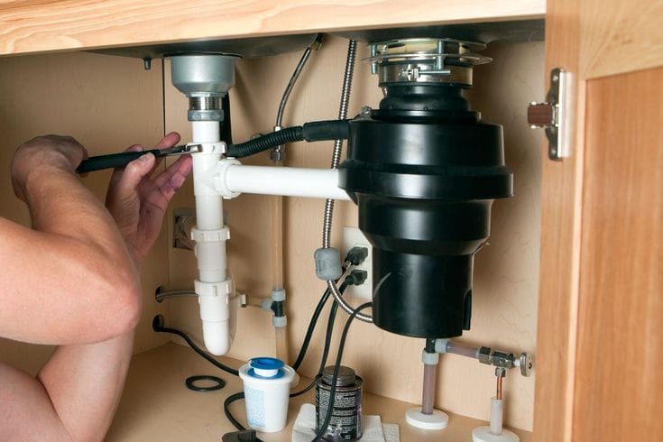Plumber repairing a garbage disposal in Granite Bay