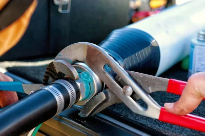 Technician repairing an industrial pipe connection in Granite Bay