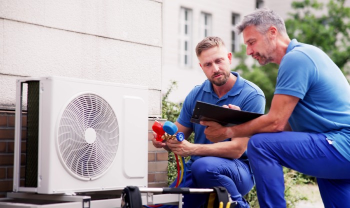 HVAC technicians installing an outdoor air conditioning unit in Granite Bay